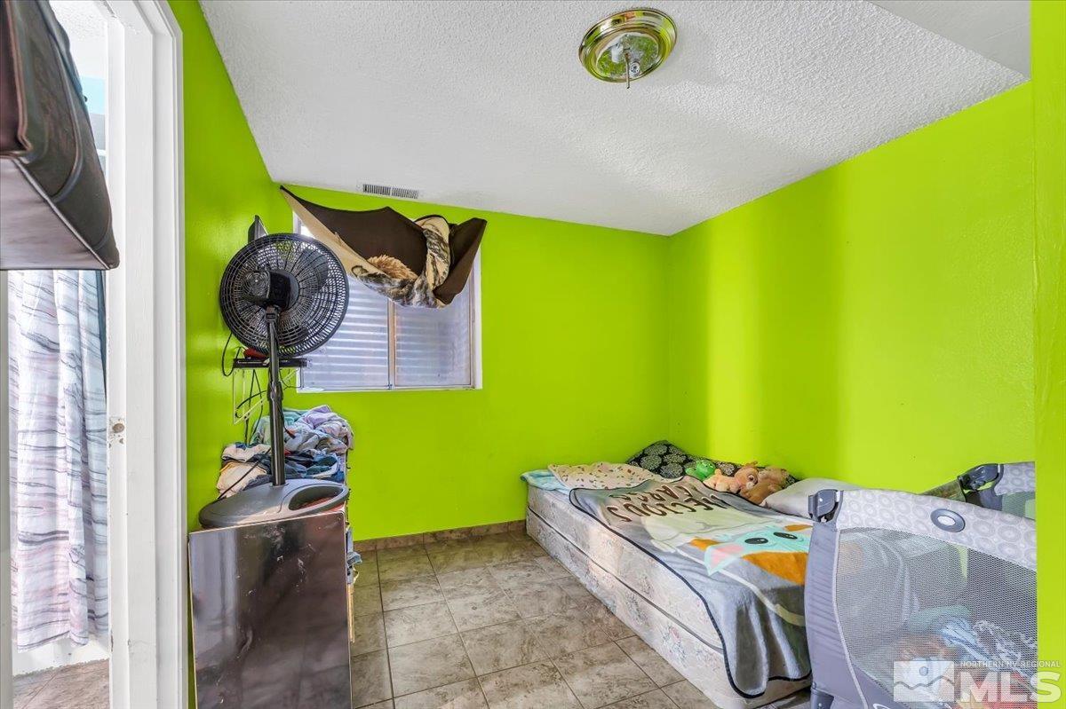 1402 East 9th Street, Unit 11 Reno, NV 89512 - Photo 19 of 25 a room with a bed and toys