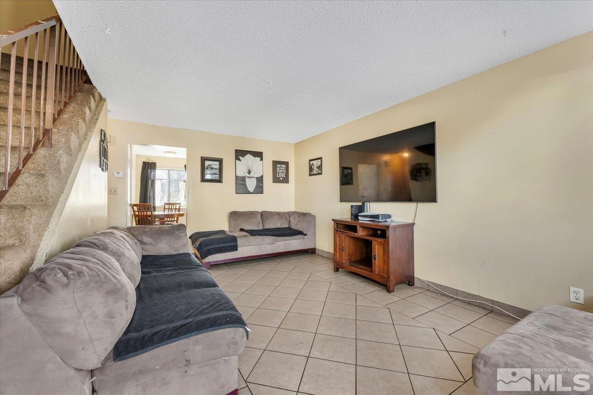 1402 East 9th Street, Unit 11 Reno, NV 89512 - Photo 4 of 25 a living room with furniture and a flat screen tv