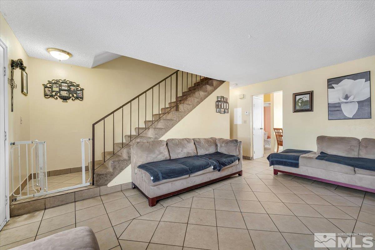 1402 East 9th Street, Unit 11 Reno, NV 89512 - Photo 5 of 25 a living room with furniture and a rug