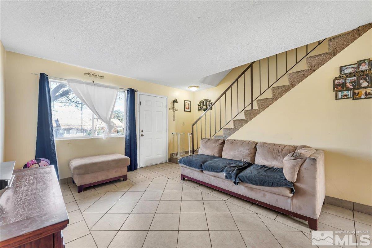 1402 East 9th Street, Unit 11 Reno, NV 89512 - Photo 6 of 25 a living room with furniture and a potted plant