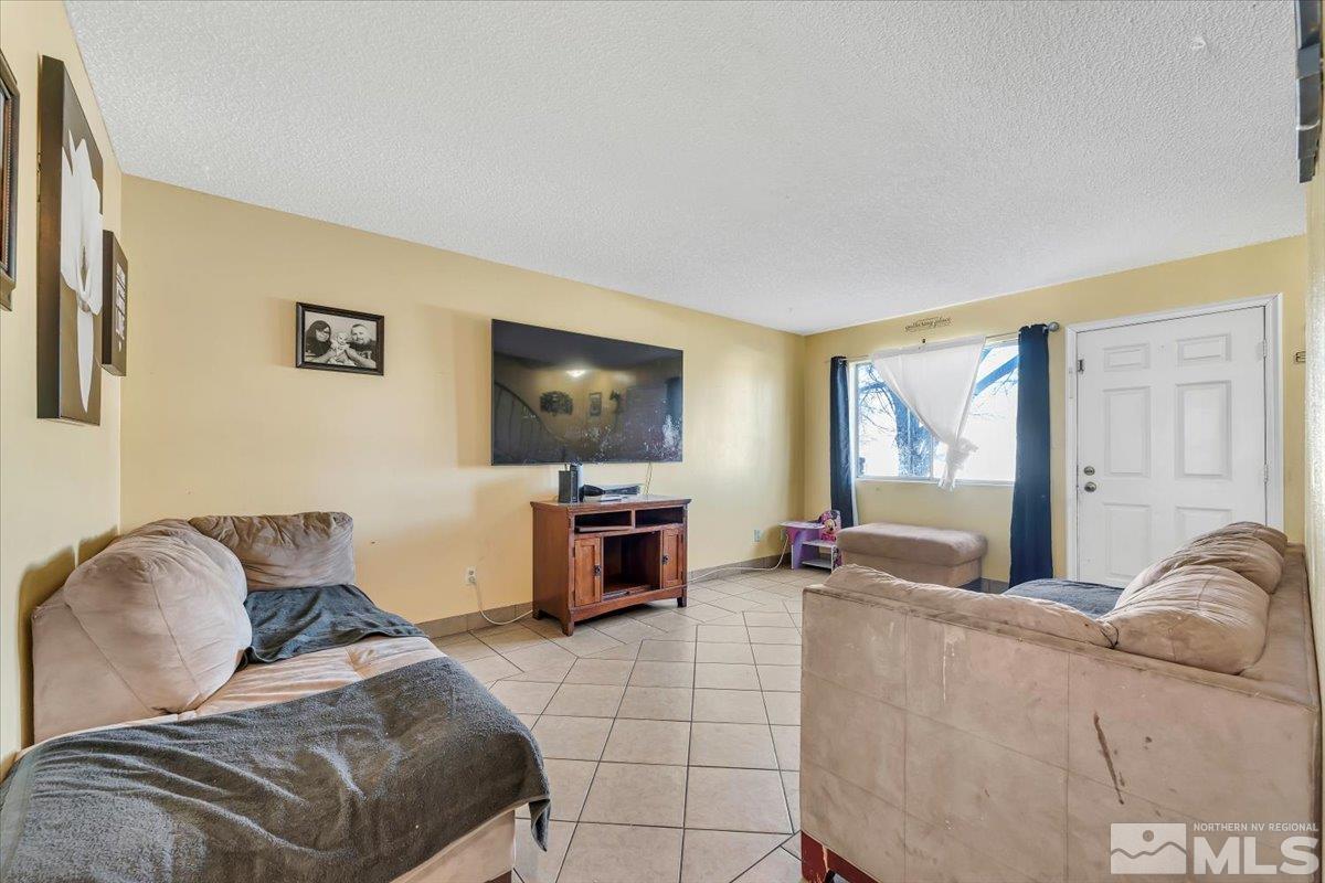 1402 East 9th Street, Unit 11 Reno, NV 89512 - Photo 7 of 25 a living room with furniture and a flat screen tv
