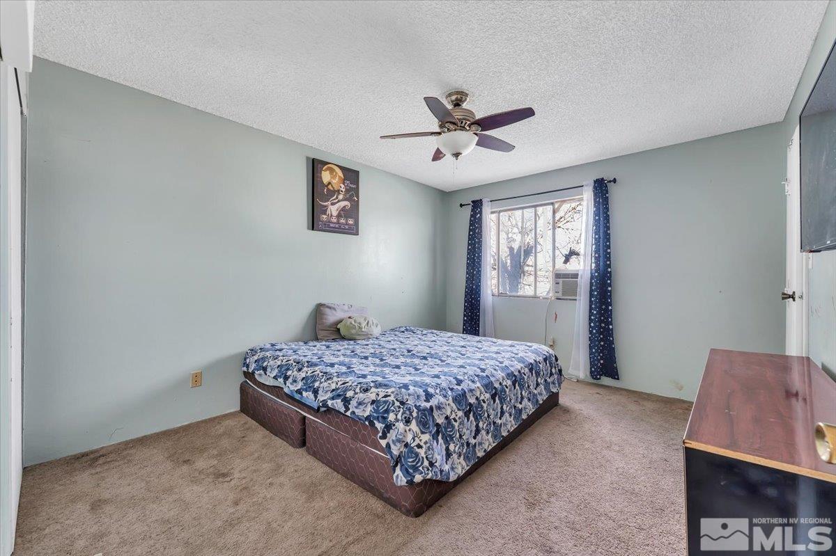 1402 East 9th Street, Unit 11 Reno, NV 89512 - Photo 9 of 25 a bedroom with a bed and dresser