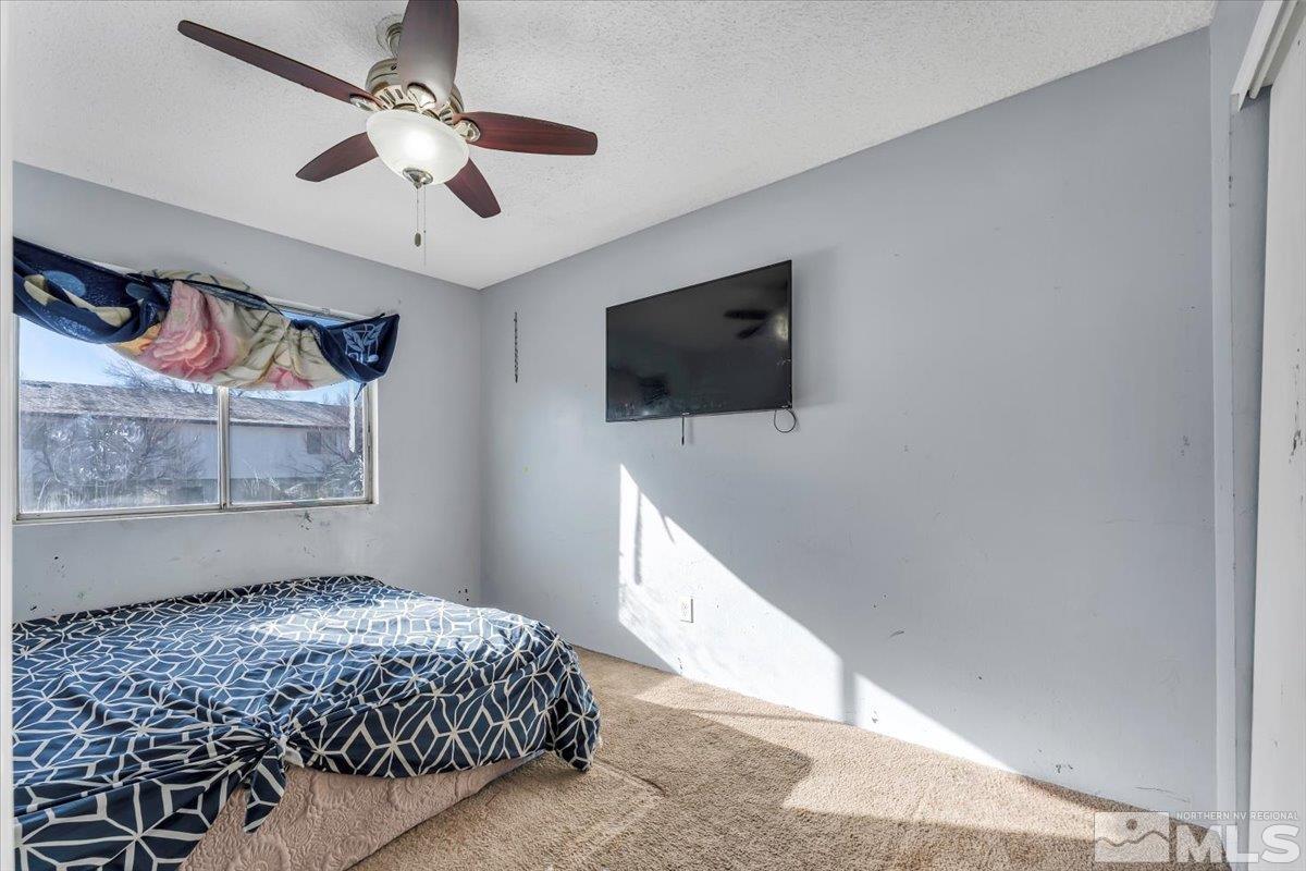 1402 East 9th Street, Unit 11 Reno, NV 89512 - Photo 10 of 25 a bedroom with a bed and a flat screen tv