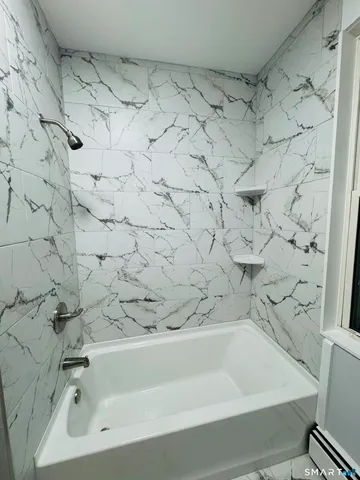 a bathroom with a bathtub and a shower