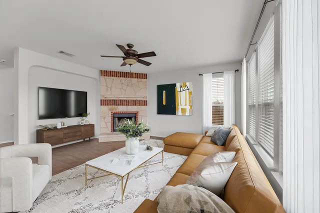 a living room with furniture a flat screen tv and a fireplace