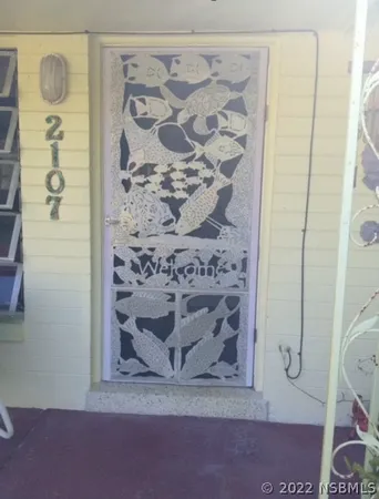 a kitchen with a table chairs a stove and a microwave