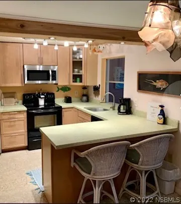 a kitchen with stainless steel appliances dining table and chairs
