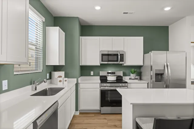 a kitchen with a sink a stove and cabinets