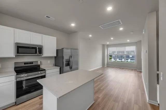 a view of kitchen with microwave and cabinets