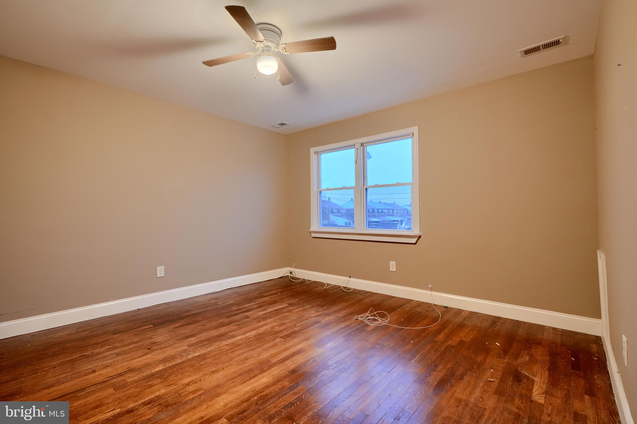 8037 North Boundary Road Dundalk, MD 21222 - Photo 13 of 36 a view of empty room with wooden floor and fan