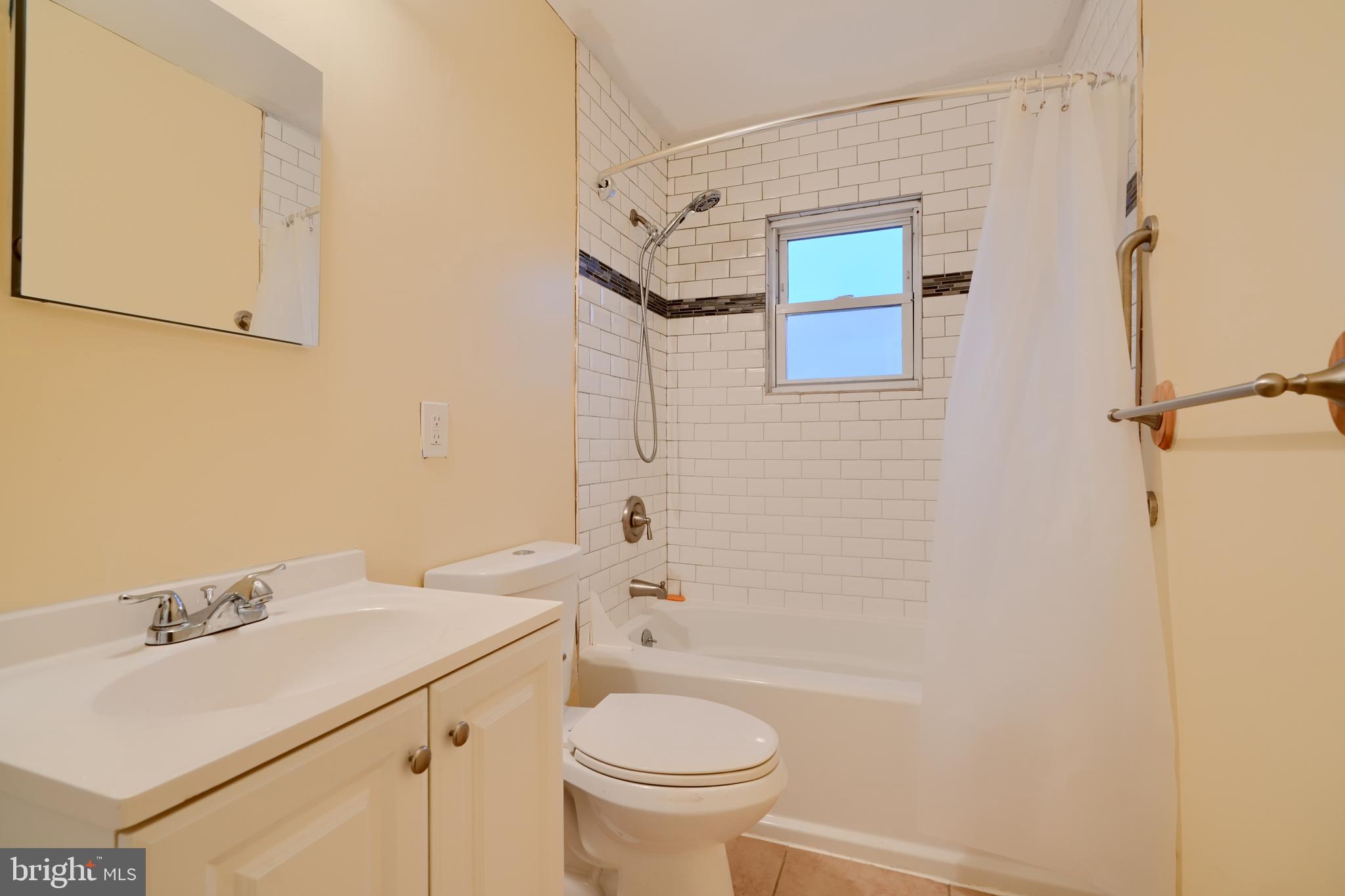 8037 North Boundary Road Dundalk, MD 21222 - Photo 20 of 36 a bathroom with a sink a toilet and shower