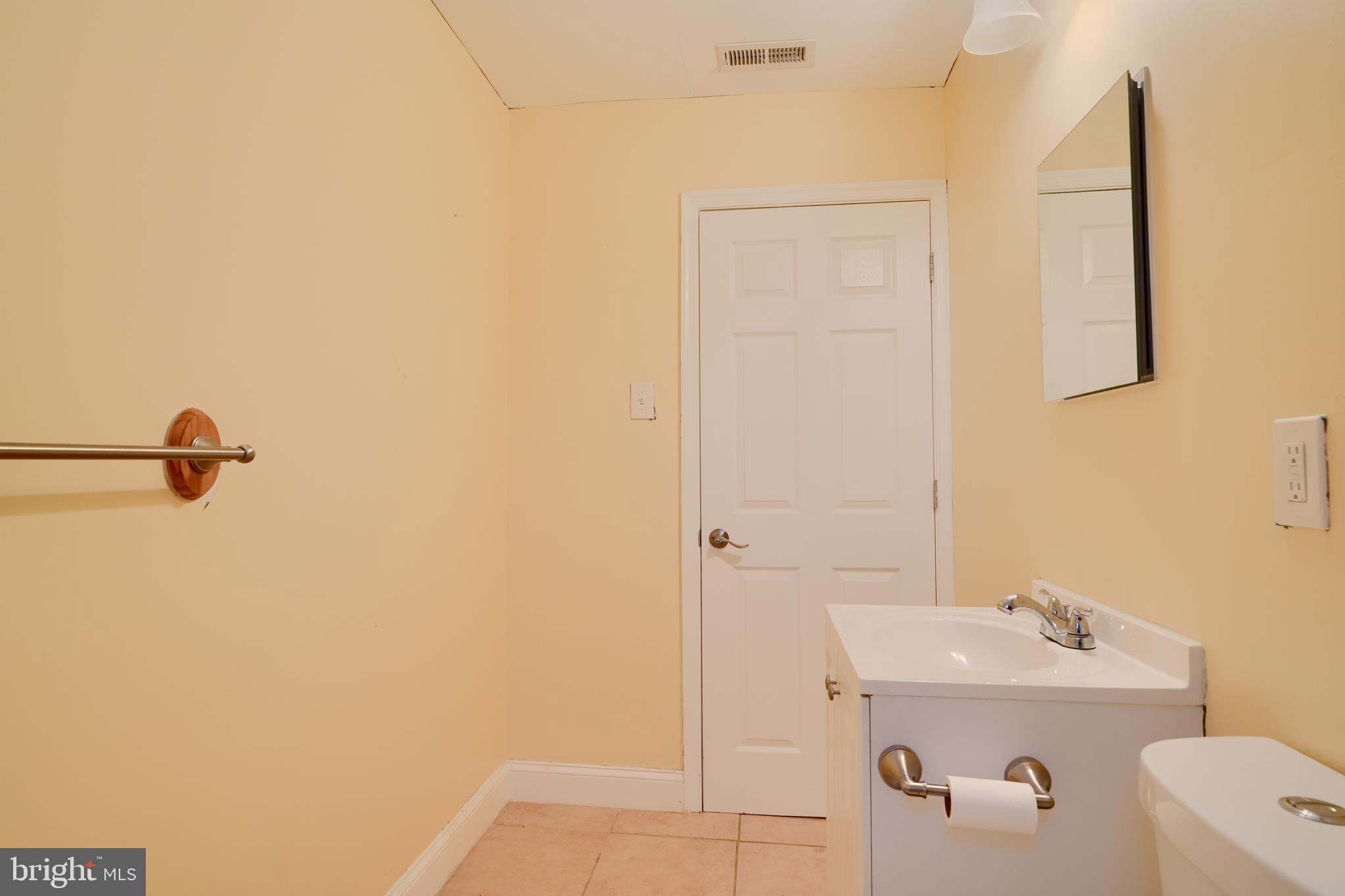 8037 North Boundary Road Dundalk, MD 21222 - Photo 21 of 36 a bathroom with a sink a toilet and shower