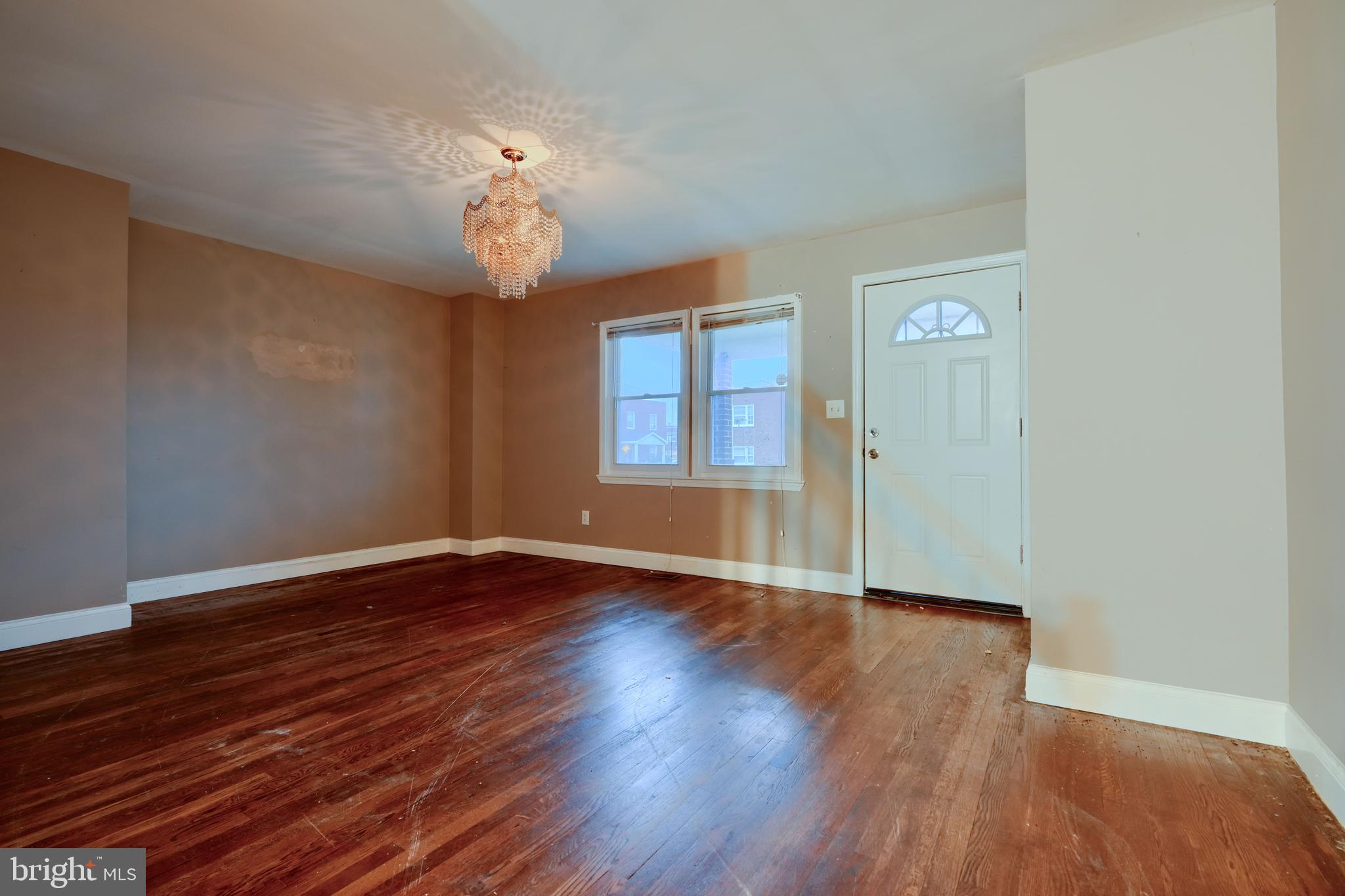 8037 North Boundary Road Dundalk, MD 21222 - Photo 5 of 36 a view of an empty room with wooden floor and a window