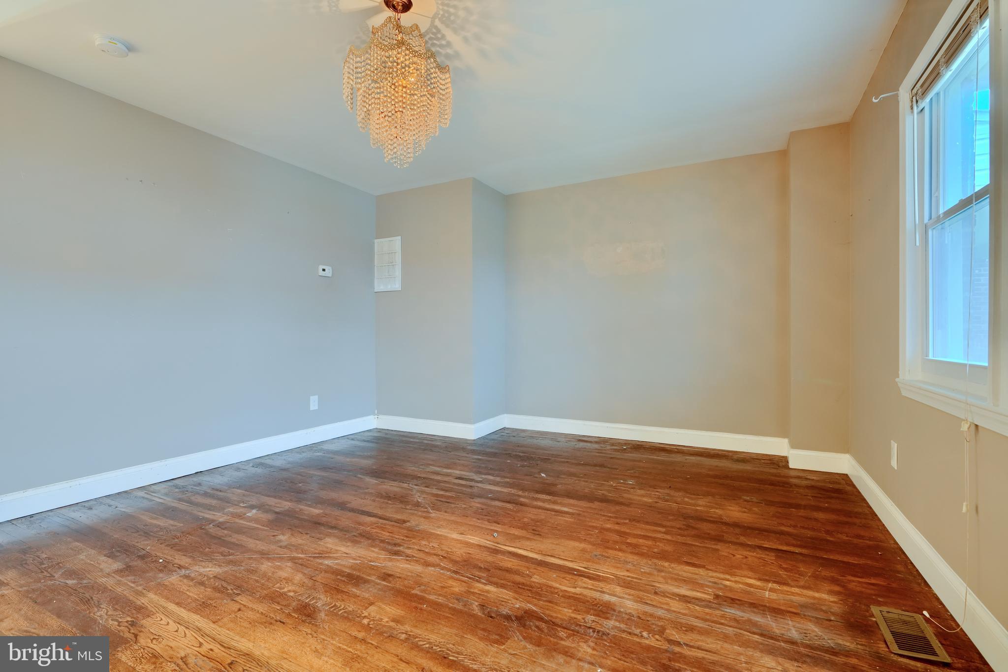 8037 North Boundary Road Dundalk, MD 21222 - Photo 6 of 36 a view of an empty room with wooden floor and a window