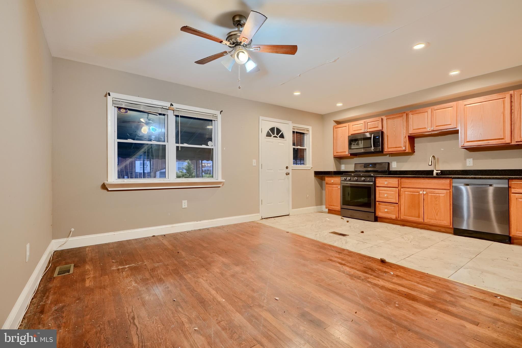8037 North Boundary Road Dundalk, MD 21222 - Photo 8 of 36 a view of kitchen with wooden floor and window
