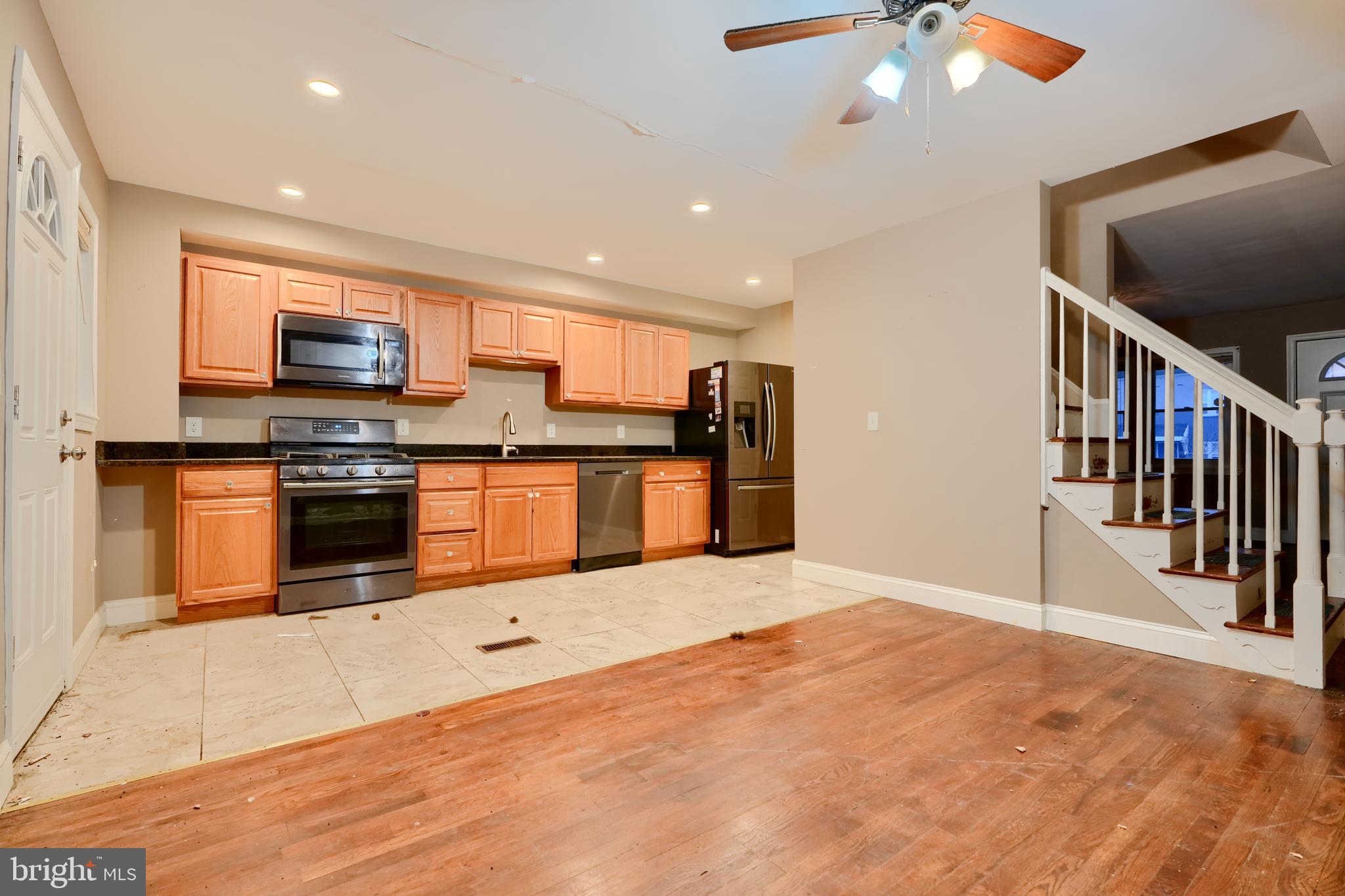 8037 North Boundary Road Dundalk, MD 21222 - Photo 9 of 36 a kitchen with stainless steel appliances kitchen island granite countertop a stove top oven a sink and a granite counter top