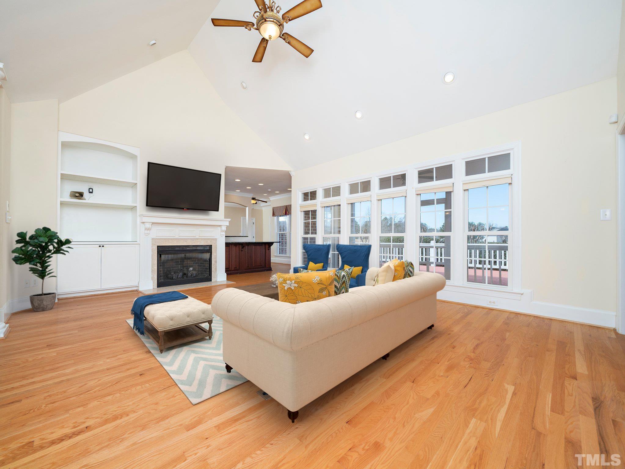 619 Competition Road Raleigh, NC 27603 - Photo 7 of 28 a living room with furniture a fireplace and a flat screen tv