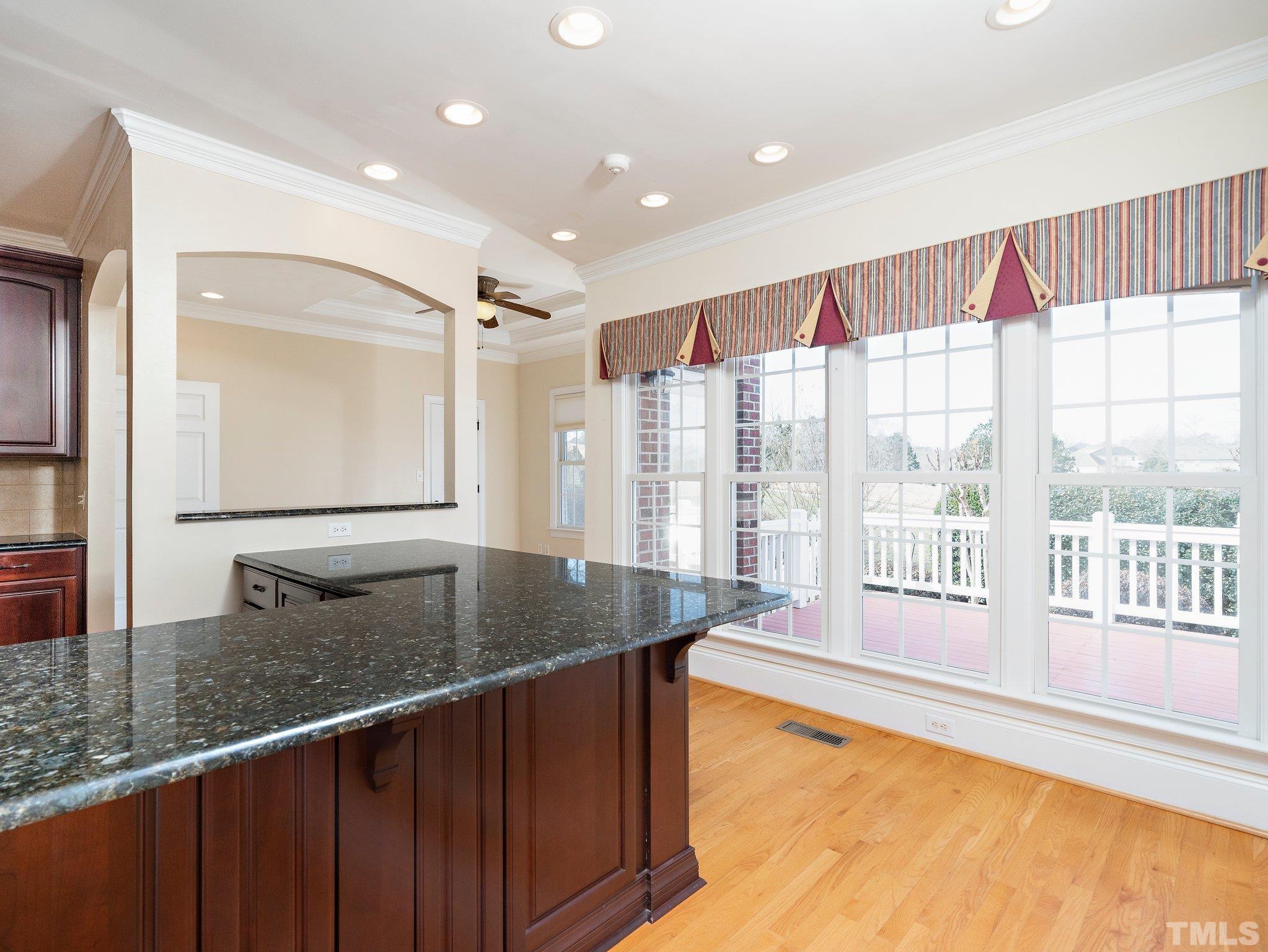 619 Competition Road Raleigh, NC 27603 - Photo 9 of 28 a kitchen with kitchen island granite countertop a sink and a large window
