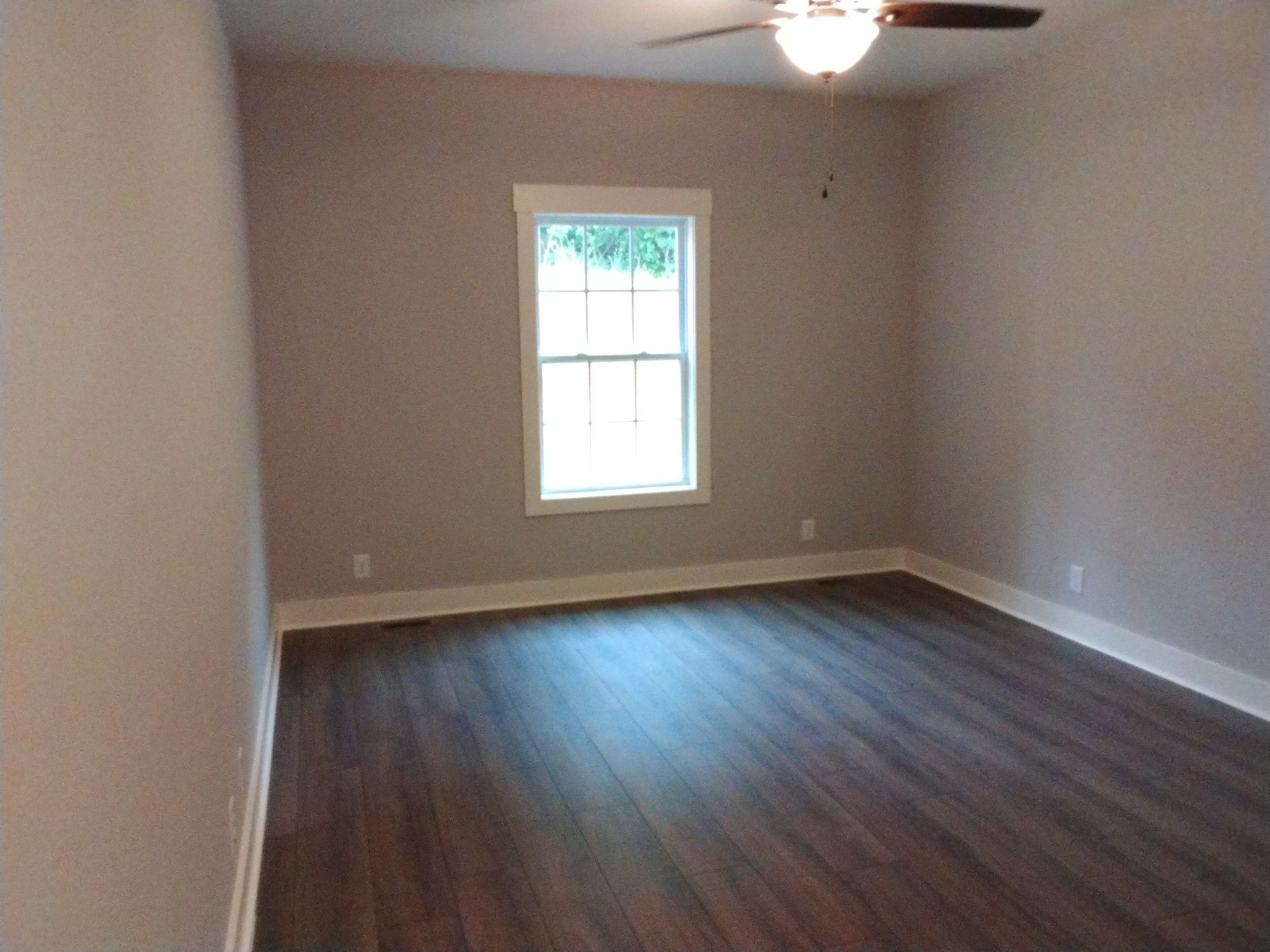 2006 McMahan Hollow Road Pleasant View, TN 37146 - Photo 8 of 20 an empty room with wooden floor and windows