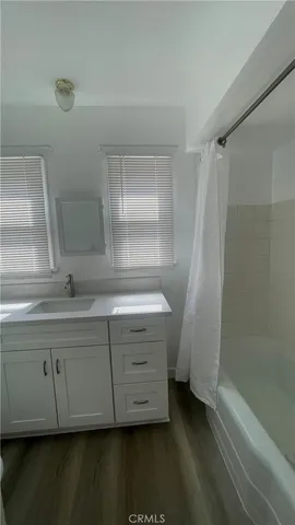 a bathroom with a double vanity sink and a mirror