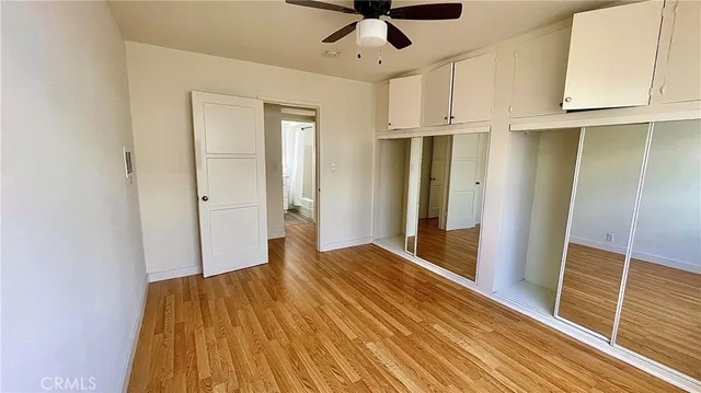 a view of a room with wooden floor and cabinet