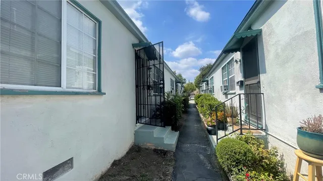 a house with potted plants in front of door