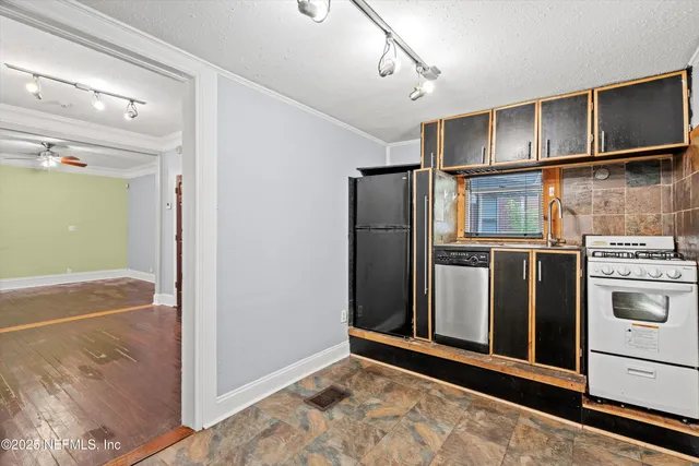 a kitchen with stainless steel appliances granite countertop a refrigerator and a sink