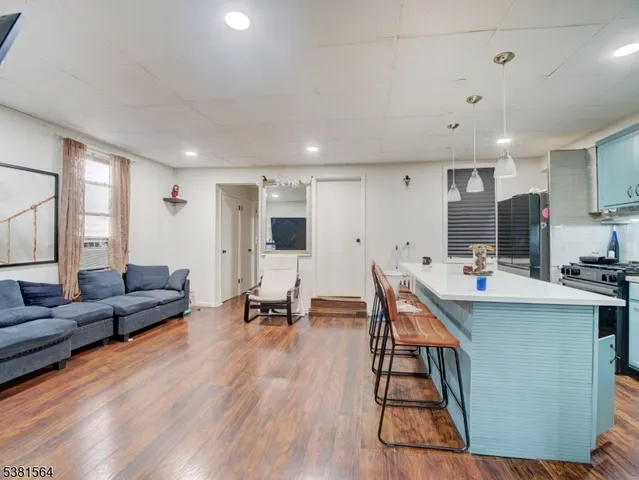 a living room with lots of furniture and kitchen view