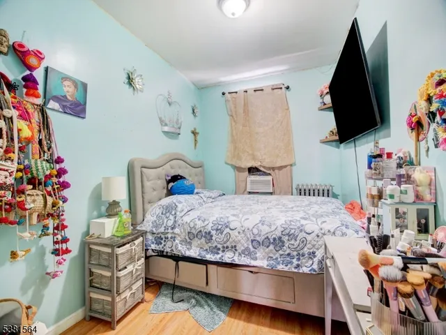 a bedroom with a bed and flat screen tv