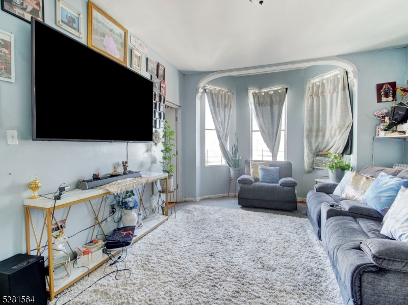 411 Monastery Place Union City, NJ 07087 - Photo 7 of 20 a living room with furniture and a flat screen tv