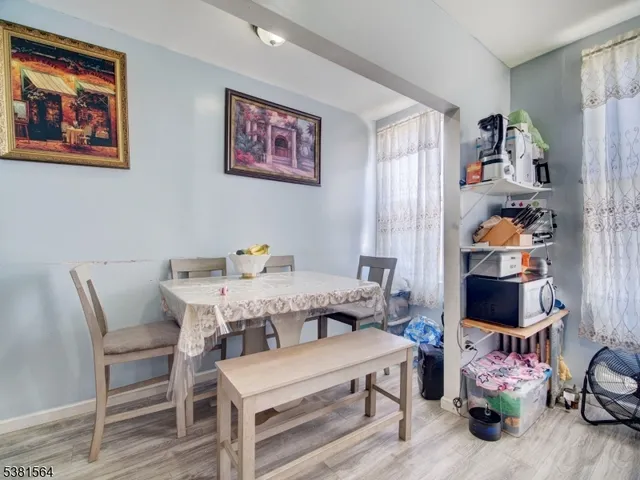 a dining room with furniture and wooden floor