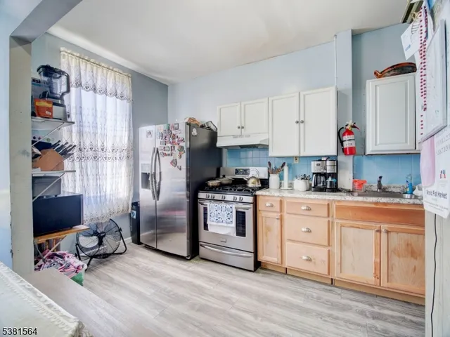 a kitchen with stainless steel appliances granite countertop a refrigerator sink and cabinets
