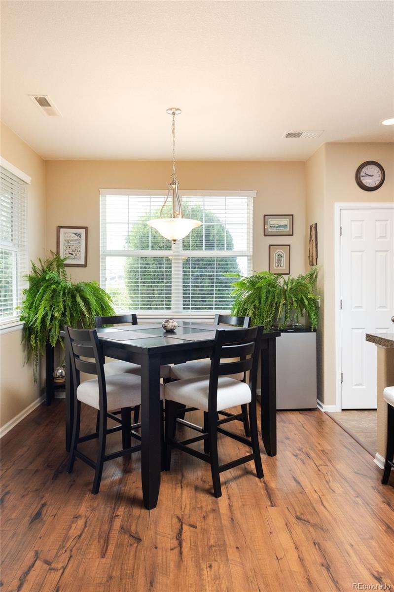 3661 South Perth Circle, Unit 6101 Aurora, CO 80013 - Photo 11 of 48 a view of a dining room with furniture window and wooden floor