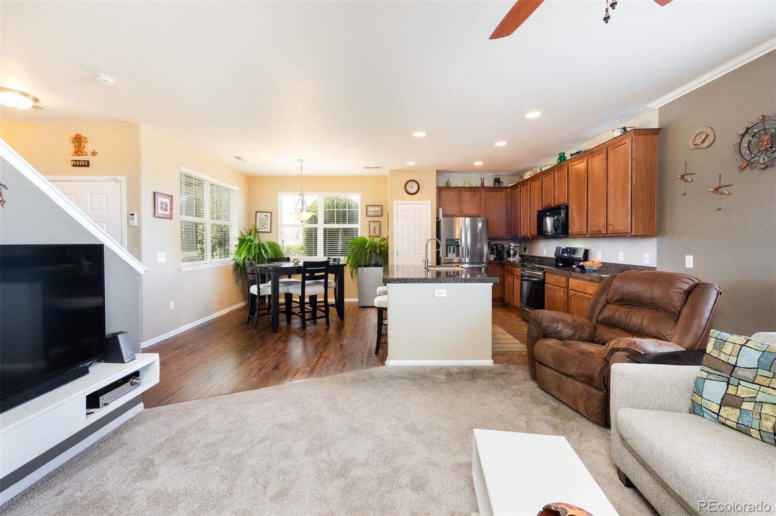 3661 South Perth Circle, Unit 6101 Aurora, CO 80013 - Photo 18 of 48 a living room with furniture and a flat screen tv