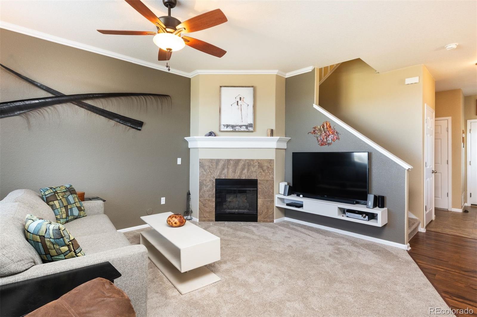 3661 South Perth Circle, Unit 6101 Aurora, CO 80013 - Photo 20 of 48 a living room with furniture a flat screen tv and a fireplace