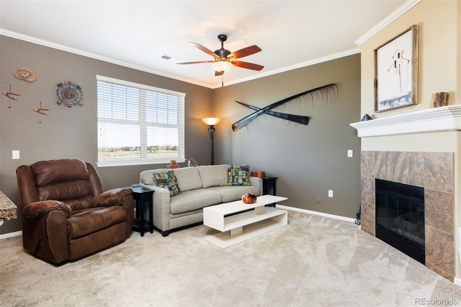 3661 South Perth Circle, Unit 6101 Aurora, CO 80013 - Photo 22 of 48 a living room with furniture and a fireplace