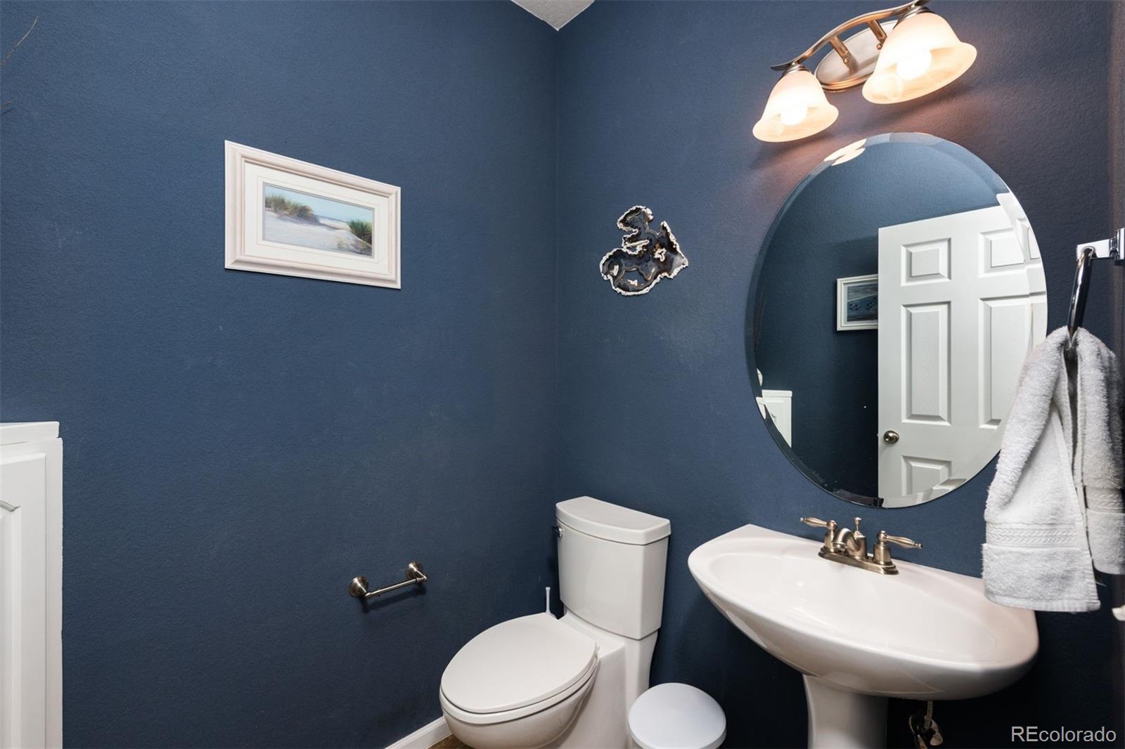 3661 South Perth Circle, Unit 6101 Aurora, CO 80013 - Photo 23 of 48 a bathroom with a toilet a sink and mirror