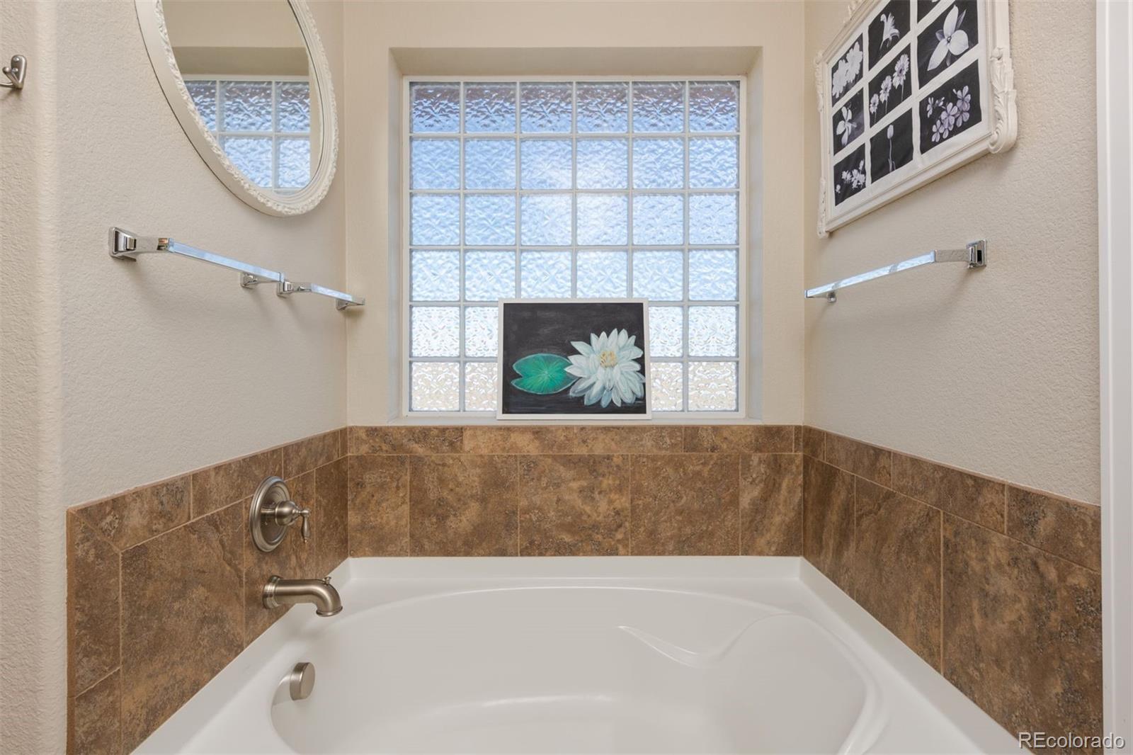 3661 South Perth Circle, Unit 6101 Aurora, CO 80013 - Photo 30 of 48 a bathroom with a tub and a window