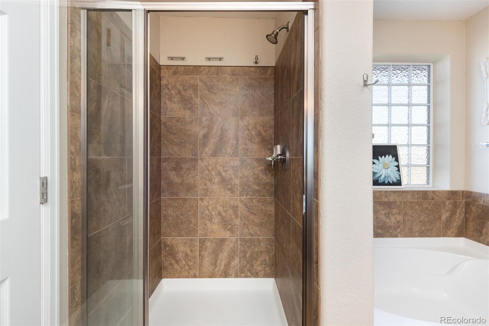 3661 South Perth Circle, Unit 6101 Aurora, CO 80013 - Photo 31 of 48 a bathroom with a tub and shower