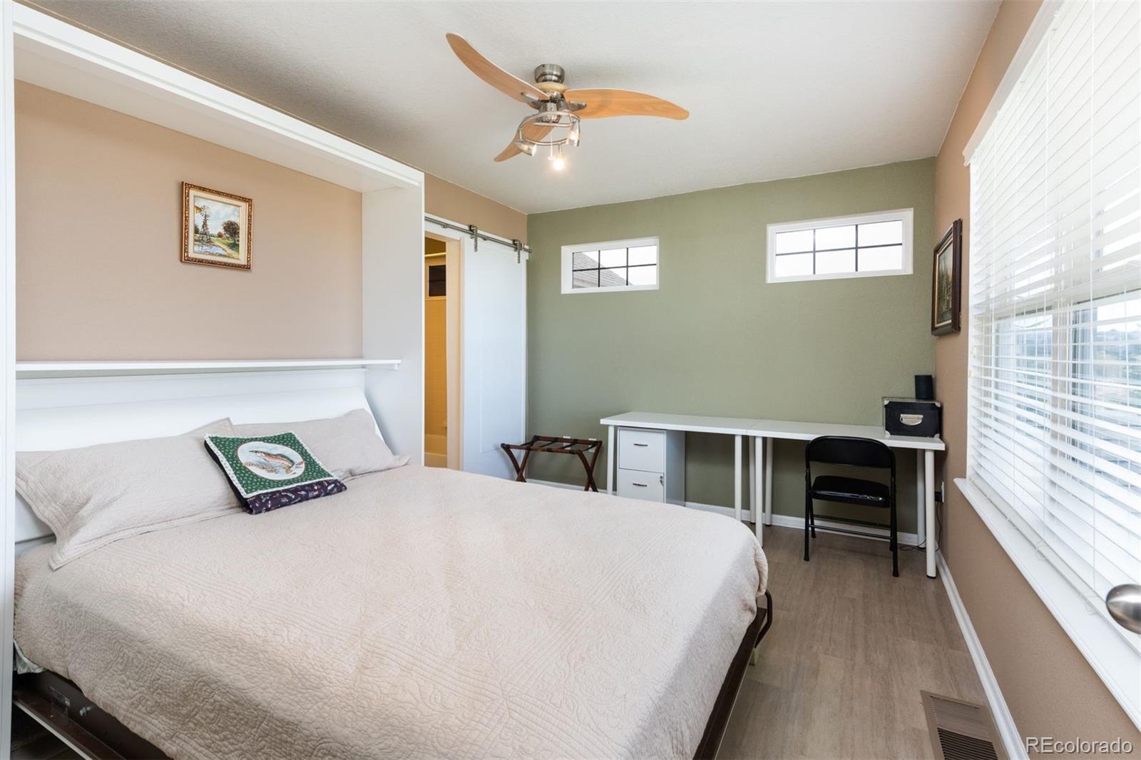 3661 South Perth Circle, Unit 6101 Aurora, CO 80013 - Photo 32 of 48 a bedroom with a bed and a window