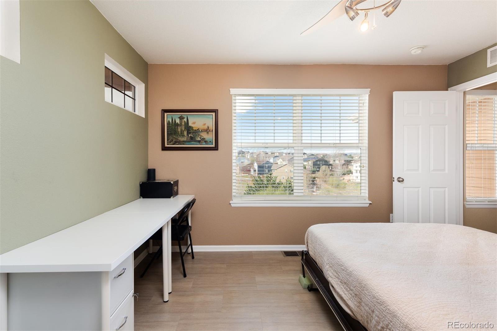 3661 South Perth Circle, Unit 6101 Aurora, CO 80013 - Photo 34 of 48 a bedroom with a bed and a window