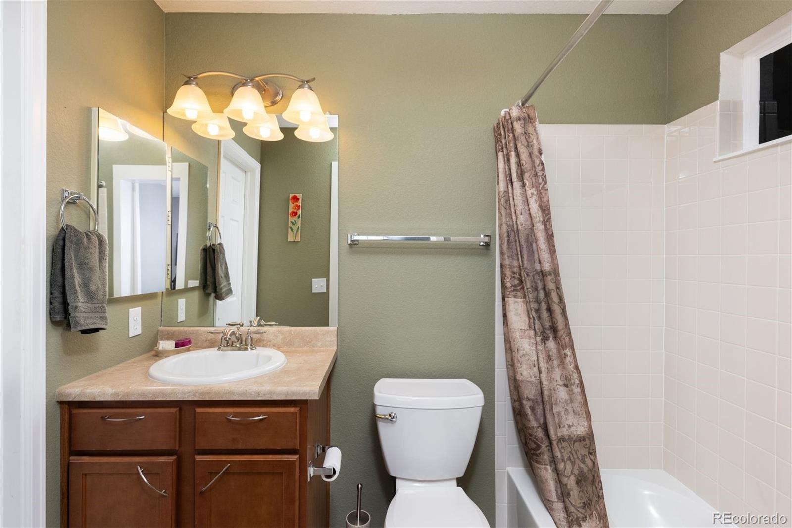 3661 South Perth Circle, Unit 6101 Aurora, CO 80013 - Photo 35 of 48 a bathroom with a sink and a mirror
