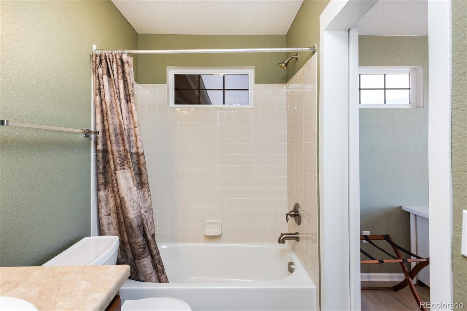 3661 South Perth Circle, Unit 6101 Aurora, CO 80013 - Photo 36 of 48 a bathroom with a bathtub and a shower