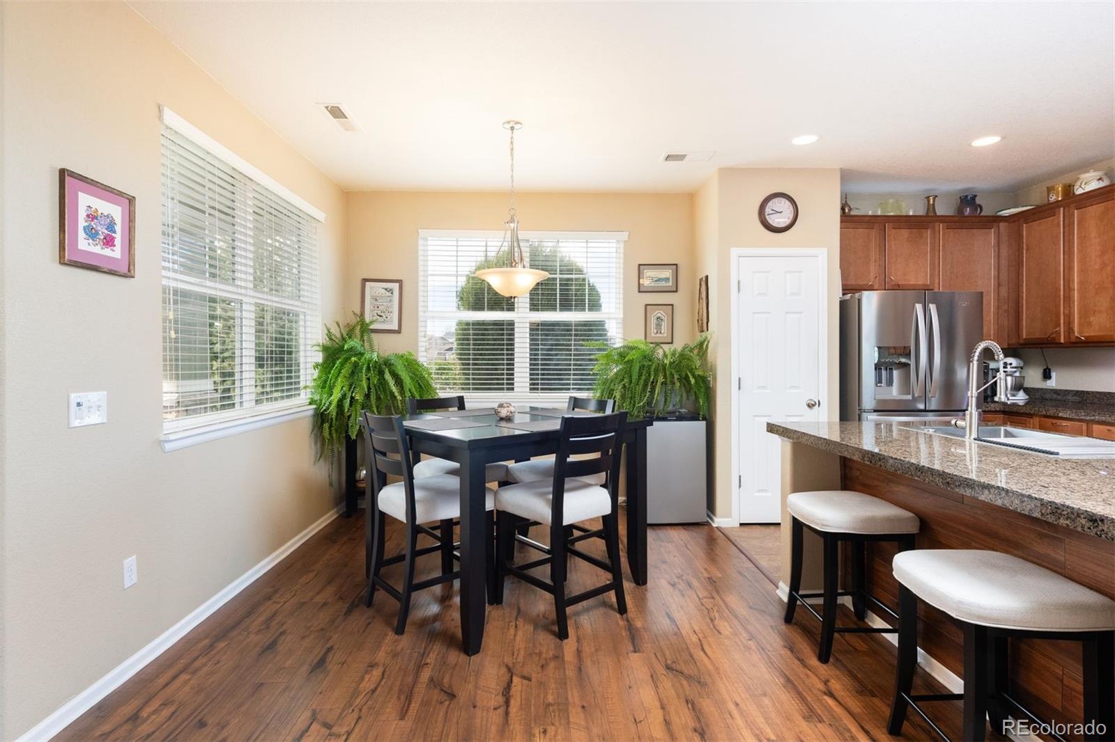 3661 South Perth Circle, Unit 6101 Aurora, CO 80013 - Photo 10 of 48 a view of a dining room with furniture window and wooden floor
