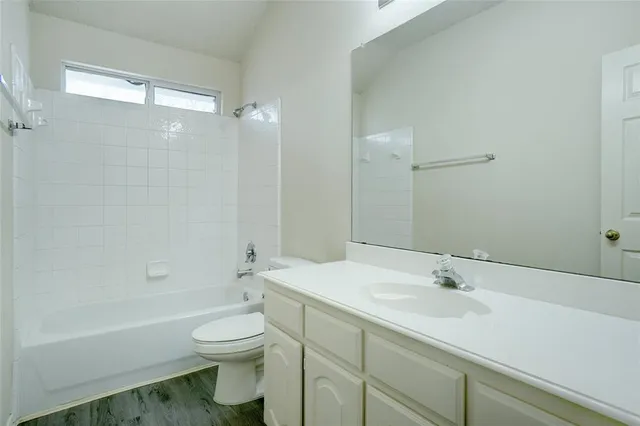 a balcony with wooden floor and fence