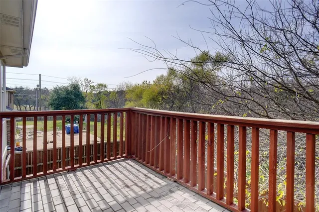 a view of a house with a yard and wooden fence