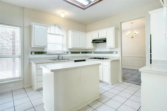 a kitchen with appliances cabinets and a sink