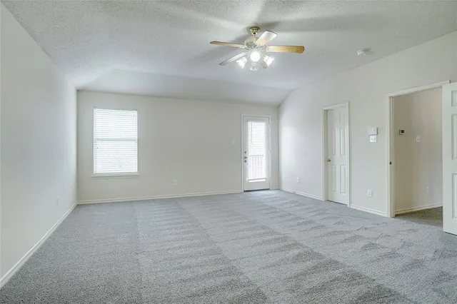 a spacious bathroom with a tub sink and mirror