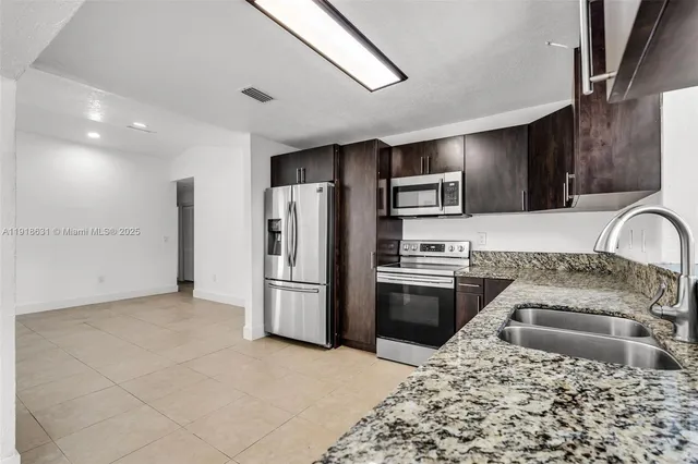 a kitchen with a sink stove and refrigerator
