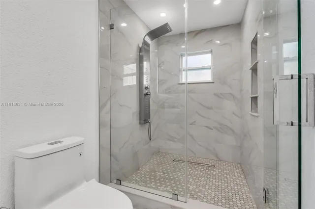 a bathroom with a shower and a toilet